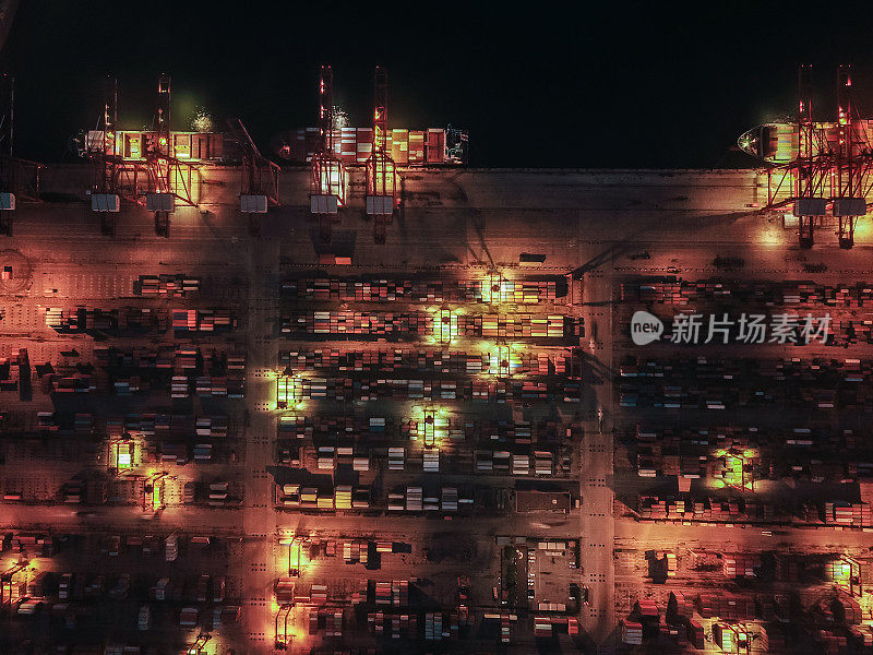 Top View of Busy Industrial Port with Containers Ship at Night